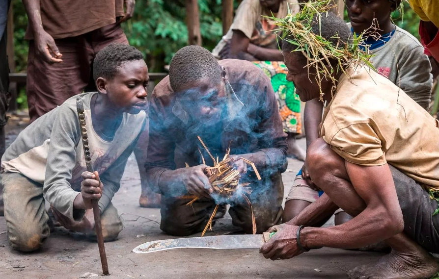 Batwa community members performing a traditional forest ritual during cultural experience in Mgahinga