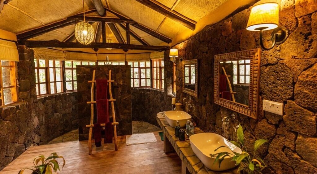A cozy stone lounge area with a fireplace and traditional African decor.