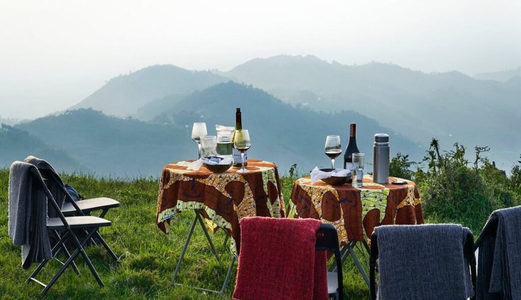 Relaxing outdoor chairs on a high ridge overlooking the expansive mountain landscape.