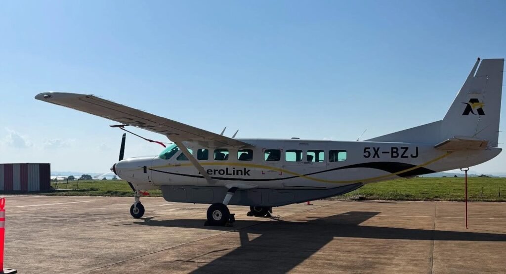 A small Aerolink bush plane on a runway, showcasing domestic flight options for gorilla trekking from Kigali or Entebbe.