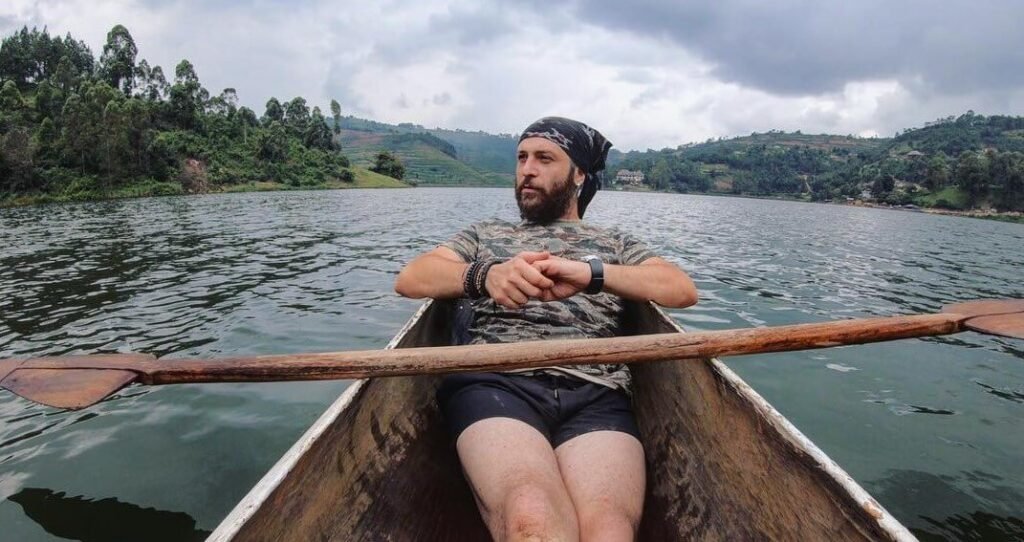 A traveler paddling a wooden canoe across the still water, reflecting the peaceful pace of life on the lake.