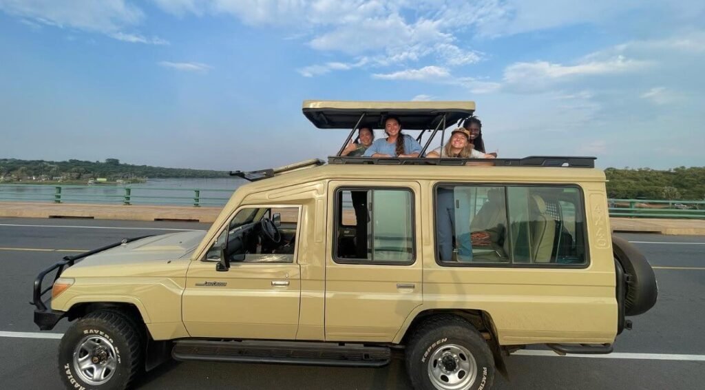 Group of smiling travelers on a safari game drive vehicle in Uganda