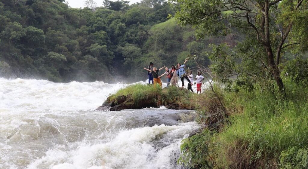 Lush green riverbanks and cascading rapids at Murchison Falls National Park Uganda
