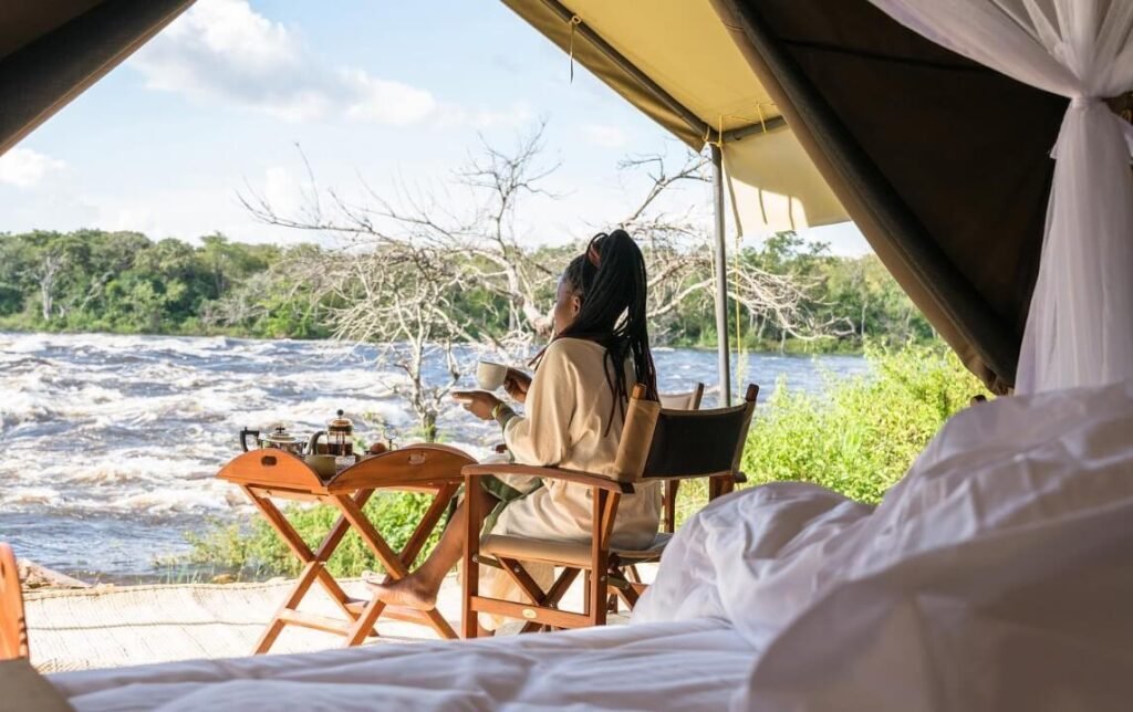 Outdoor dining table set up with views over the Murchison Falls landscape at Papas Camp Uganda