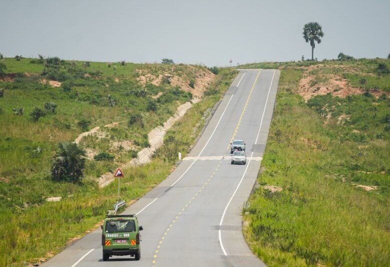 An aerial view of the road cutting through the green landscape of Murchison Falls National Park
