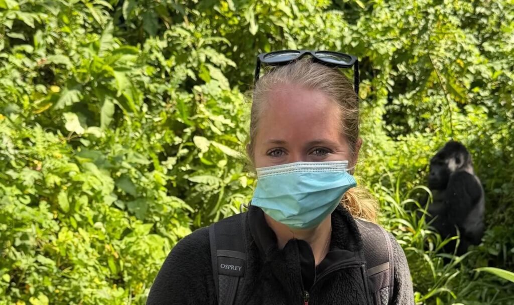 Another close-up selfie of a trekker with a wild mountain gorilla, highlighting the proximity of the encounter.