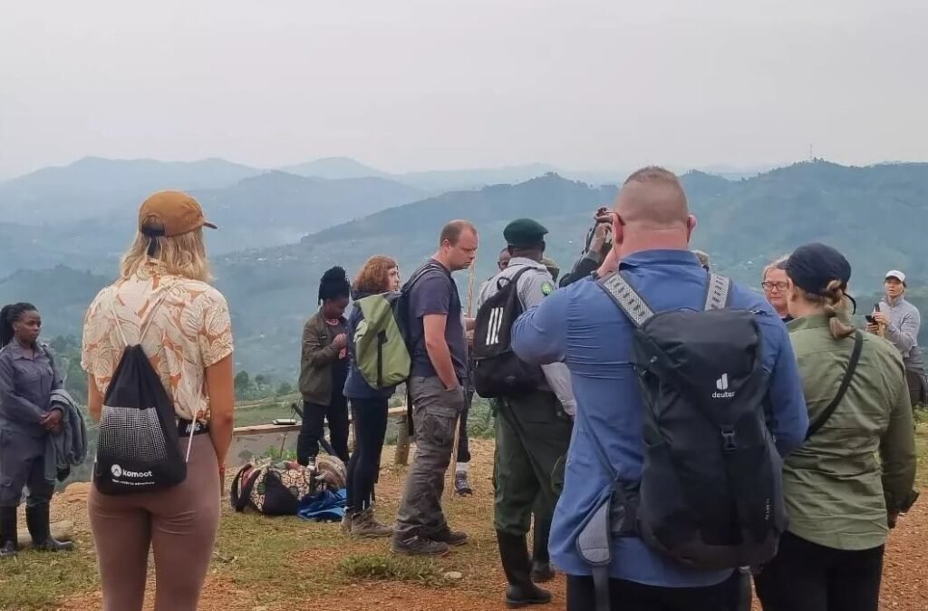 A group of travelers standing in a circle outdoors for their pre-trek safety and orientation briefing.