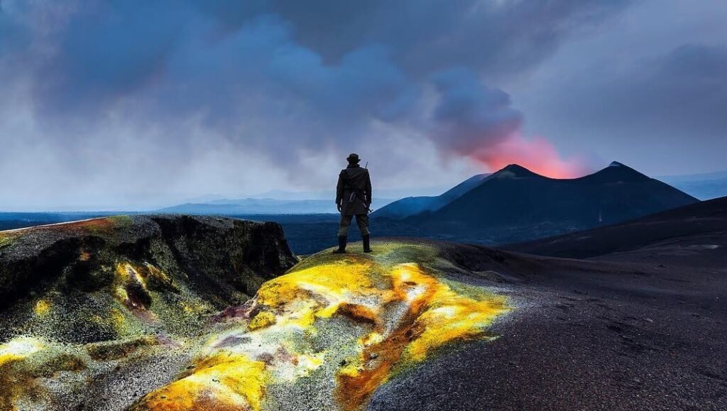 Virunga volcano erupting at dusk, viewed from Mgahinga Gorilla National Park, Uganda