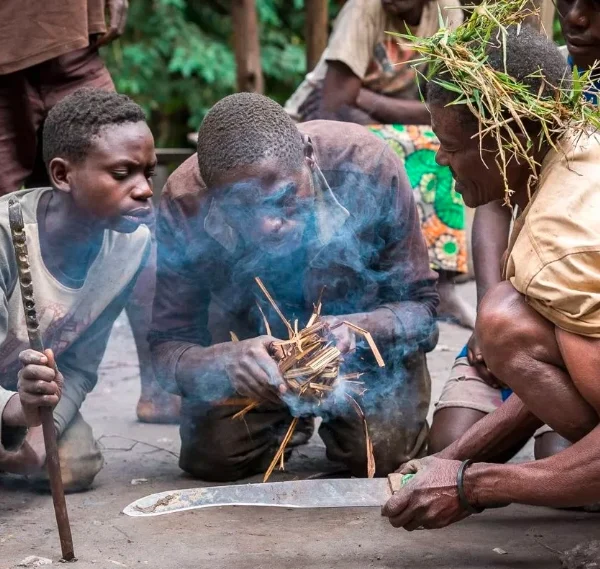Batwa community members performing a traditional forest ritual during cultural experience in Mgahinga