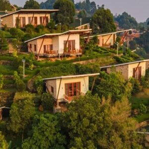 Stone cottages arranged on a terraced hillside with spectacular views of the southern Bwindi forest.