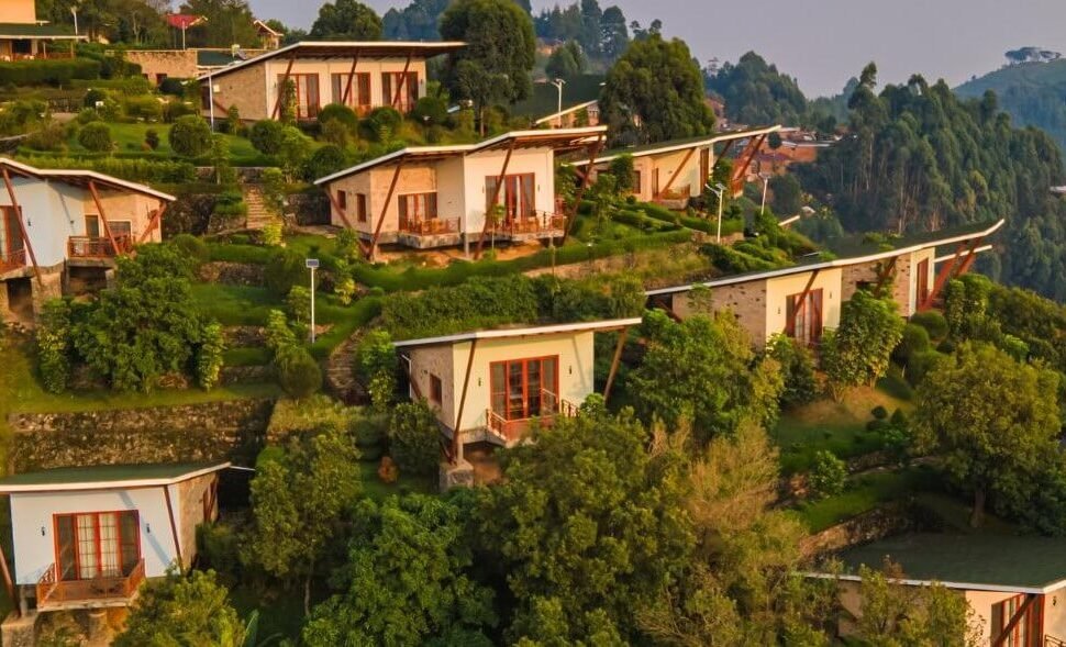 Stone cottages arranged on a terraced hillside with spectacular views of the southern Bwindi forest.