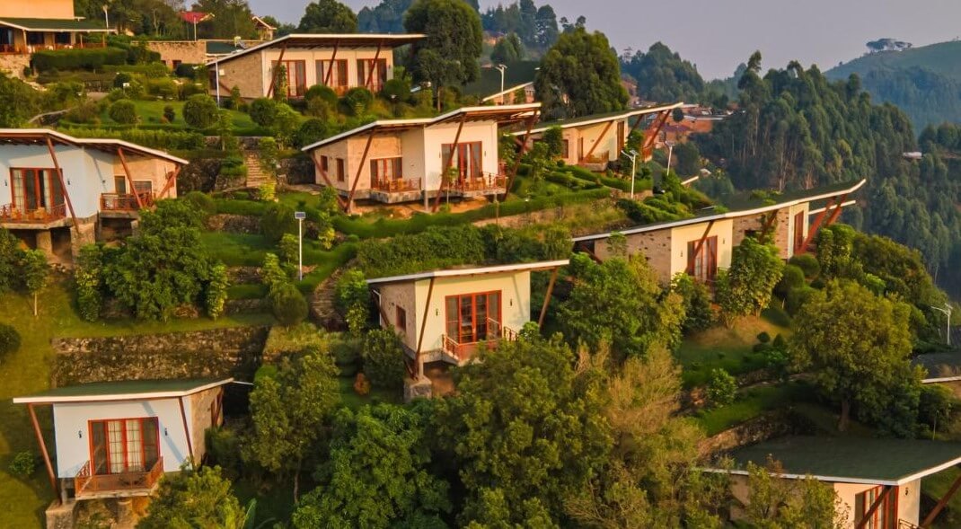 Stone cottages arranged on a terraced hillside with spectacular views of the southern Bwindi forest.