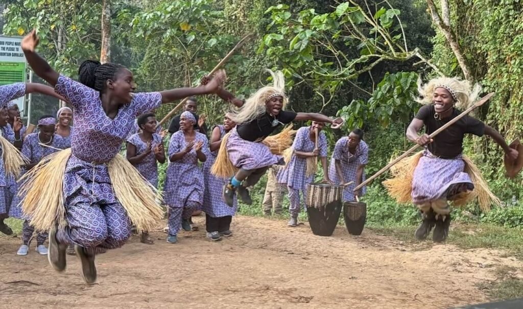 Local Batwa or community dancers performing a traditional dance for safari guests.