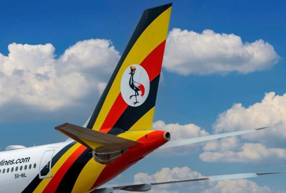 Uganda Airlines tail fin against a blue sky with clouds