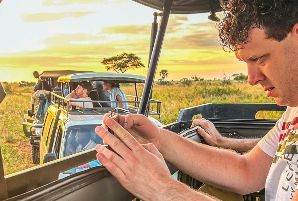 Tourist reviewing a map during a game drive on a Uganda wildlife safari