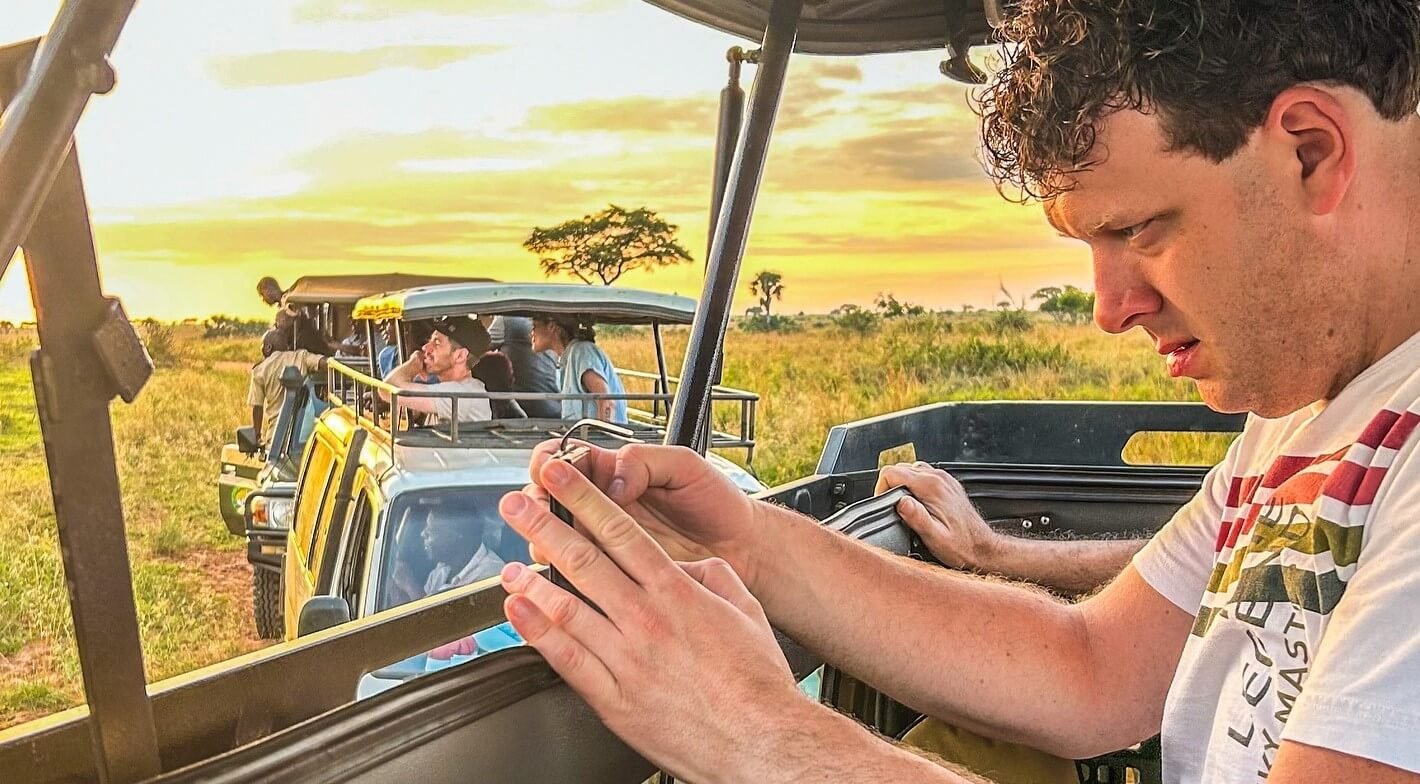 Tourist reviewing a map during a game drive on a Uganda wildlife safari